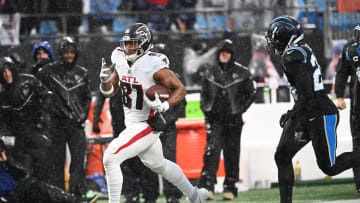 Dec 17, 2023; Charlotte, North Carolina, USA;  Atlanta Falcons tight end Jonnu Smith (81) with the ball as Carolina Panthers safety Vonn Bell (24) defends in the second quarter at Bank of America Stadium. Mandatory Credit: Bob Donnan-USA TODAY Sports