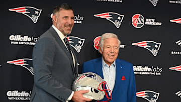 Vrabel stands with Robert Kraft at his introductory press conference with the Patriots.