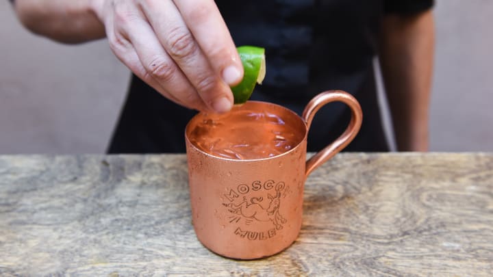 Bartender finishing a Moscow Mule