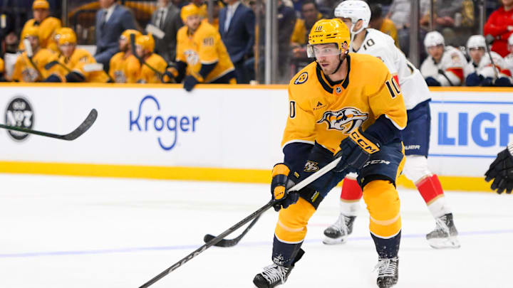 Feb 25, 2025; Nashville, Tennessee, USA;  Nashville Predators center Colton Sissons (10) skates with the puck against the Florida Panthers during the third period at Bridgestone Arena. Mandatory Credit: Steve Roberts-Imagn Images
