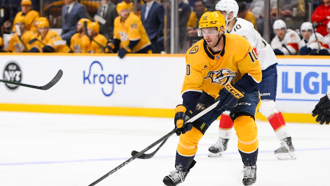Feb 25, 2025; Nashville, Tennessee, USA;  Nashville Predators center Colton Sissons (10) skates with the puck against the Florida Panthers during the third period at Bridgestone Arena. Mandatory Credit: Steve Roberts-Imagn Images