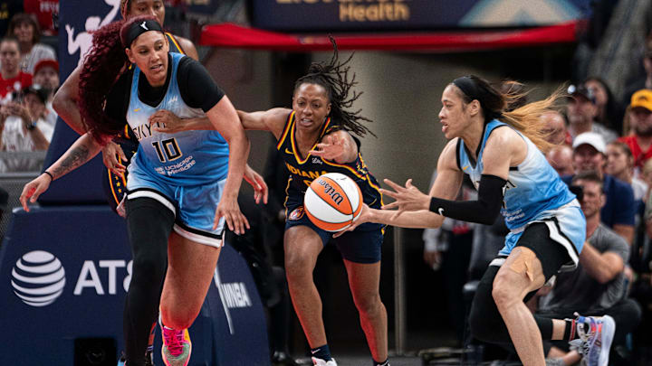 Indiana Fever guard Kelsey Mitchell (0) looks to grab a rebound while being guarded by Chicago Sky guard Chennedy Carter (7) and Chicago Sky center Kamilla Cardoso (10) on Sunday June 16, 2024, during the game at Gainbridge Fieldhouse in Indianapolis. The Fever beat the Sky 91-83.