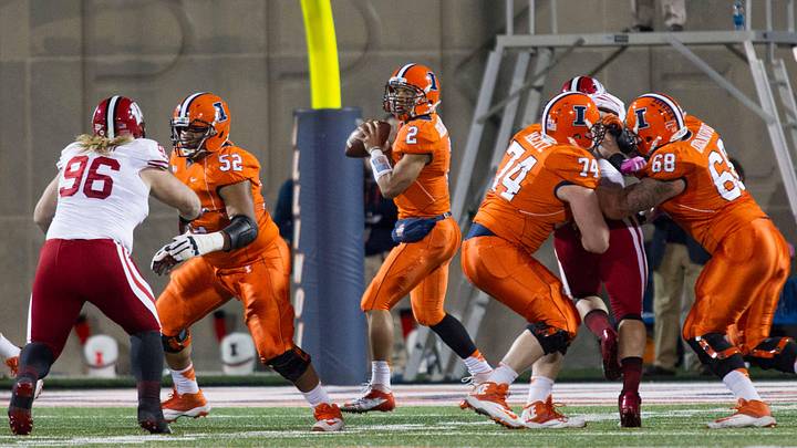 Oct 19, 2013; Champaign, IL, USA; Illinois Fighting Illini quarterback Nathan Scheelhaase (2) stands in the pocket created by offensive linesman Alex Hill (52), offensive linesman Michael Heitz (74) and offensive linesman Simon Cvijanovic (68) to pass the ball in the second quarter of the game against the Wisconsin Badgers at Memorial Stadium. Wisconsin wins 56-32 over Illinois. Mandatory Credit: Trevor Ruszkowksi-Imagn Images
