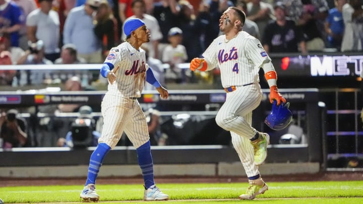 Aug 19, 2024; New York City, New York, USA; New York Mets shortstop Francisco Lindor (12) congratulates New York Mets catcher Francisco Alvarez (4) for hitting a walk off home run against the Baltimore Orioles during the ninth inning at Citi Field. Mandatory Credit: Gregory Fisher-USA TODAY Sports