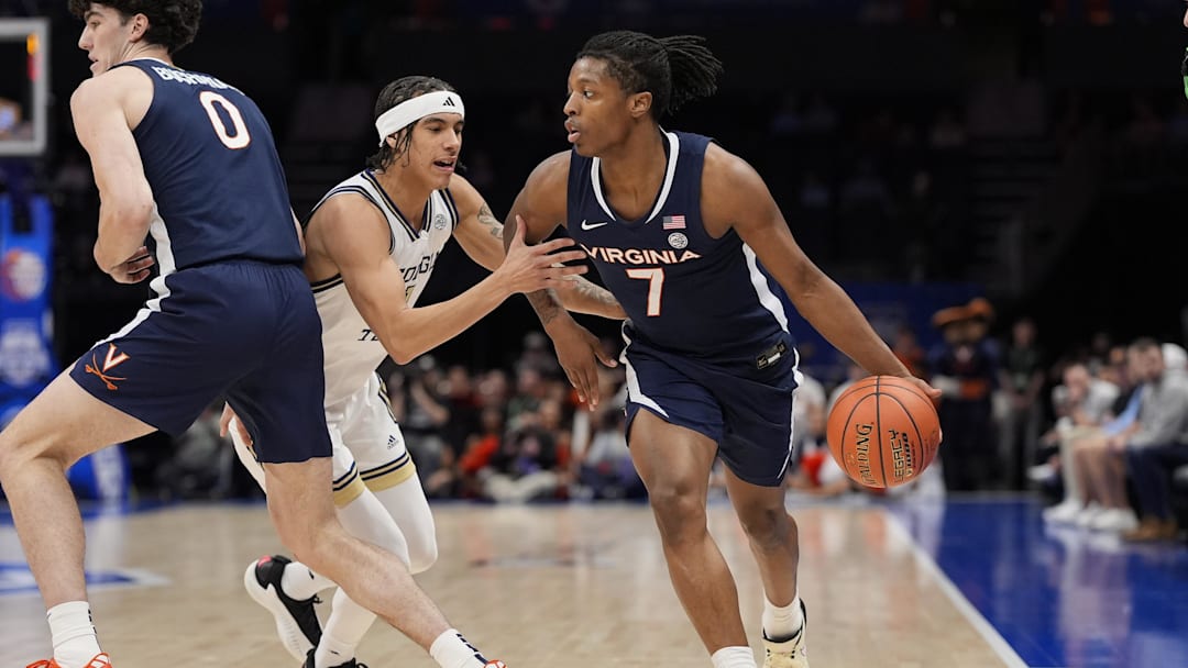 Mar 12, 2025; Charlotte, NC, USA; Virginia Cavaliers guard Dai Dai Ames (7) handles the ball against Georgia Tech Yellow Jackets guard Lance Terry (0) during the first half at Spectrum Center. Mandatory Credit: Jim Dedmon-Imagn Images