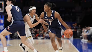 Mar 12, 2025; Charlotte, NC, USA; Virginia Cavaliers guard Dai Dai Ames (7) handles the ball against Georgia Tech Yellow Jackets guard Lance Terry (0) during the first half at Spectrum Center. Mandatory Credit: Jim Dedmon-Imagn Images