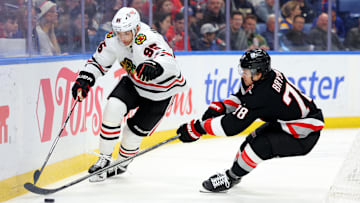 Dec 27, 2024; Buffalo, New York, USA;  Chicago Blackhawks right wing Ilya Mikheyev (95) and Buffalo Sabres defenseman Jacob Bryson (78) go after a loose puck during the first period at KeyBank Center. Mandatory Credit: Timothy T. Ludwig-Imagn Images