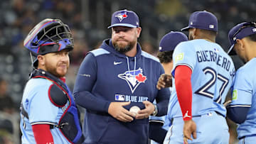 Apr 1, 2025; Toronto, Ontario, CAN; Toronto Blue Jays manager John Schneider (center) visits the pitching mound along with catcher Alejandro Kirk (30) during the eighth inning against the Washington Nationals at Rogers Centre. 