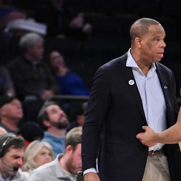 Dec 21, 2024; New York, NY, USA; North Carolina Tar Heels head coach Hubert Davis talks to guard Seth Trimble (7) during the first half against the UCLA Bruins at Madison Square Garden. Mandatory Credit: John Jones-Imagn Images
