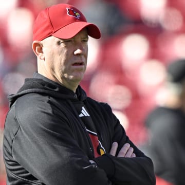 Nov 25, 2023; Louisville, Kentucky, USA;  Louisville Cardinals head coach Jeff Brohm watches warmups before the first half against the Kentucky Wildcats at L&N Federal Credit Union Stadium.