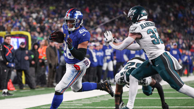 Jan 7, 2024; East Rutherford, New Jersey, USA; New York Giants running back Saquon Barkley (26) scores a rushing touchdown as