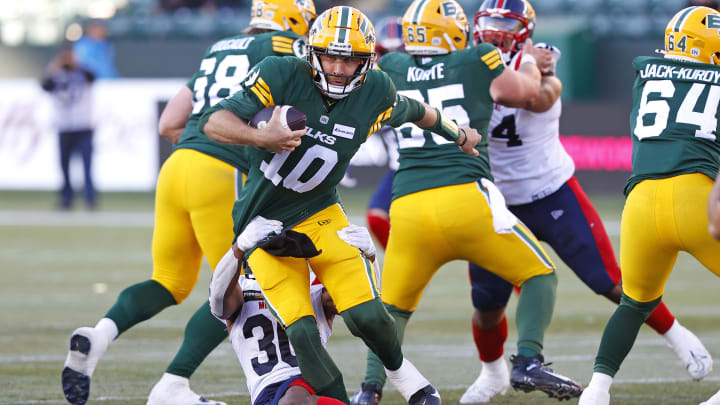 Jun 14, 2024; Edmonton, Alberta, CAN; Montreal Alouettes defensive end Avery Ellis tackles Edmonton Elks quarterback McLeod Bethel-Thompson(10) during the first half at Commonwealth Stadium. Mandatory Credit: Perry Nelson-USA TODAY Sports