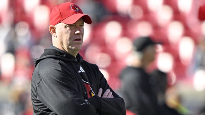 Nov 25, 2023; Louisville, Kentucky, USA;  Louisville Cardinals head coach Jeff Brohm watches warmups before the first half against the Kentucky Wildcats at L&N Federal Credit Union Stadium. 