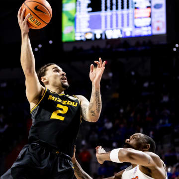 Jan 14, 2023; Gainesville, Florida, USA; Missouri Tigers guard Tre Gomillion (2) makes a layup over Florida Gators guard Kyle Lofton (11) during the first half at Exactech Arena at the Stephen C. O'Connell Center. Mandatory Credit: Matt Pendleton-USA TODAY Sports
