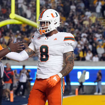 Miami Hurricanes quarterback Cam Ward (1) is congratulated by tight end Elijah Arroyo (8) after scoring a touchdown against the California Golden Bears during the fourth quarter at California Memorial Stadium. 