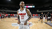 TheVille's Chane Behanan smiles while carrying the team's placard after the team defeated Jackson TN at the TBT second round of the Louisville Regional at Freedom Hall July 27, 2023.