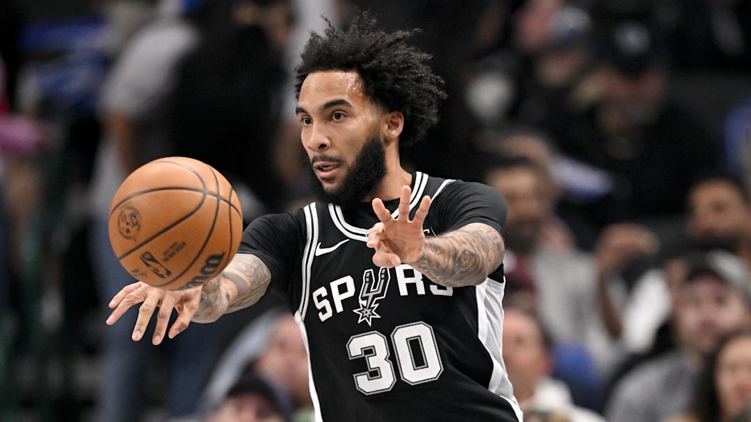 Feb 5, 2026; Dallas, Texas, USA; San Antonio Spurs forward Julian Champagnie (30) passes the ball during the first quarter against the Dallas Mavericks at the American Airlines Center.