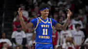 Feb 2, 2025; Cincinnati, Ohio, USA;  West Virginia Mountaineers guard Jonathan Powell (11) reacts to the crowd in the game against the Cincinnati Bearcats in the first half at Fifth Third Arena. Mandatory Credit: Aaron Doster-Imagn Images