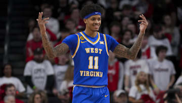 Feb 2, 2025; Cincinnati, Ohio, USA;  West Virginia Mountaineers guard Jonathan Powell (11) reacts to the crowd in the game against the Cincinnati Bearcats in the first half at Fifth Third Arena. Mandatory Credit: Aaron Doster-Imagn Images