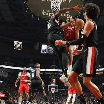 Feb 10, 2024; Portland, Oregon, USA; New Orleans Pelicans shooting guard Trey Murphy III (25) shoots under pressure from Portland Trail Blazers center Ibou Badji (41) during the first half at Moda Center. Mandatory Credit: Soobum Im-Imagn Images