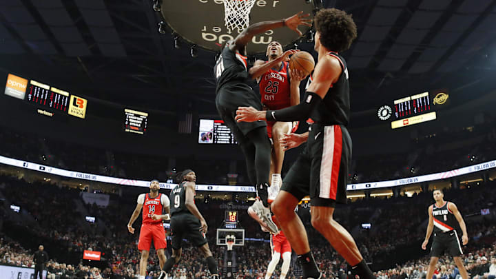 Feb 10, 2024; Portland, Oregon, USA; New Orleans Pelicans shooting guard Trey Murphy III (25) shoots under pressure from Portland Trail Blazers center Ibou Badji (41) during the first half at Moda Center. Mandatory Credit: Soobum Im-Imagn Images