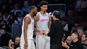 Mar 8, 2025; Miami, Florida, USA; Miami Heat head coach Erik Spoelstra talks to center Kel'el Ware (7) and forward Andrew Wiggins (22) against the Chicago Bulls during the third quarter at Kaseya Center. Mandatory Credit: Sam Navarro-Imagn Images