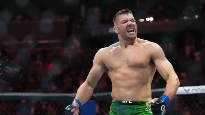 Jul 8, 2023; Las Vegas, Nevada, USA; Dricus Du Plessis (blue gloves) reacts after defeating Robert Whittaker (red gloves) during UFC 290 at T-Mobile Arena. Mandatory Credit: Stephen R. Sylvanie-USA TODAY Sports