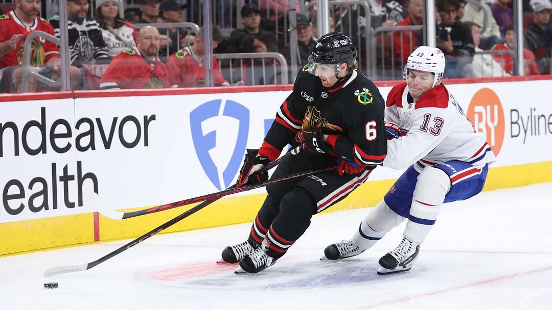 Oct 23, 2026; Chicago, Illinois, USA;  Chicago Blackhawks defenseman Sam Rinzel (6) and Montreal Canadiens right wing Cole Caufield (13) battle for control of the puck during the second period at United Center. Mandatory Credit: Talia Sprague-Imagn Images