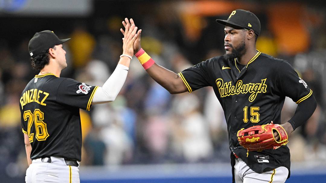 Aug 25, 2026; San Diego, California, USA;  Pittsburgh Pirates center fielder Oneil Cruz (15) and shortstop Jacob Gonzalez (26) celebrate after the Pirates beat the San Diego Padres at Petco Park.  Mandatory Credit: Denis Poroy-Imagn Images