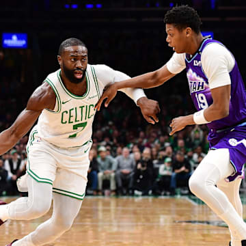 Nov 3, 2025; Boston, Massachusetts, USA; Boston Celtics guard Jaylen Brown (7) controls the ball while Utah Jazz guard Ace Bailey (19) defends during the first half at TD Garden. Mandatory Credit: Bob DeChiara-Imagn Images