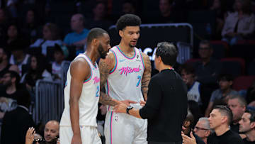 Mar 8, 2025; Miami, Florida, USA; Miami Heat head coach Erik Spoelstra talks to center Kel'el Ware (7) and forward Andrew Wiggins (22) against the Chicago Bulls during the third quarter at Kaseya Center. Mandatory Credit: Sam Navarro-Imagn Images