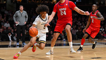 Dec 3, 2025; Nashville, Tennessee, USA;  Vanderbilt Commodores guard Tyler Tanner (3) drives baseline past Southern Methodist University Mustangs center Samet Yigitoglu (24) during the second half at Memorial Gymnasium. Mandatory Credit: Steve Roberts-Imagn Images