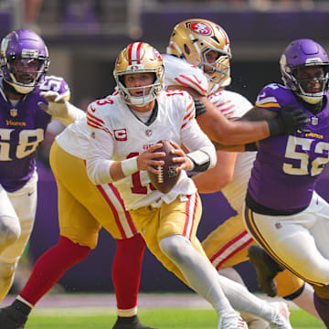 Sep 15, 2024; Minneapolis, Minnesota, USA; San Francisco 49ers quarterback Brock Purdy (13) scrambles against the Minnesota Vikings in the second quarter at U.S. Bank Stadium. Mandatory Credit: Brad Rempel-Imagn Images