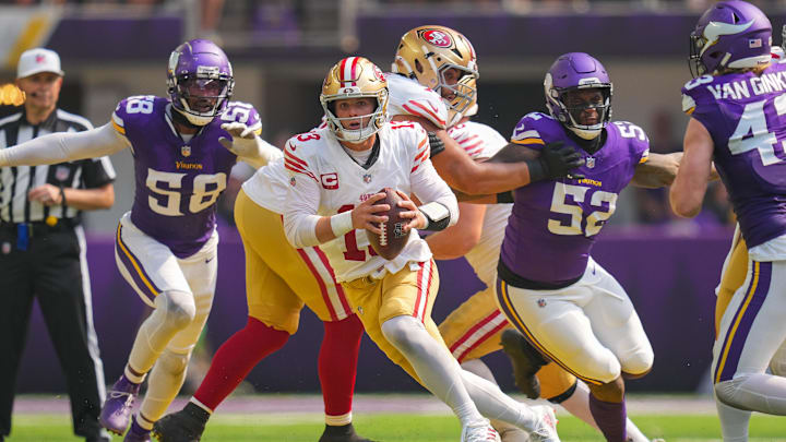 Sep 15, 2024; Minneapolis, Minnesota, USA; San Francisco 49ers quarterback Brock Purdy (13) scrambles against the Minnesota Vikings in the second quarter at U.S. Bank Stadium. Mandatory Credit: Brad Rempel-Imagn Images