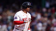 May 8, 2025; Boston, Massachusetts, USA; Boston Red Sox designated hitter Rafael Devers (11) hits a home run against the Texas Rangers in the seventh inning at Fenway Park. Mandatory Credit: David Butler II-Imagn Images