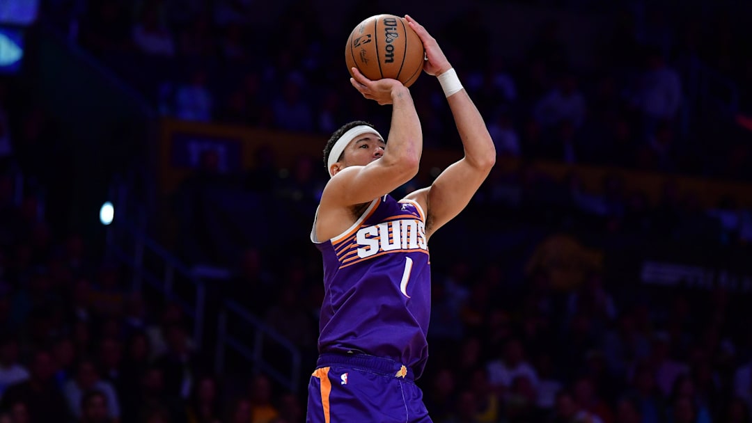 Dec 1, 2025; Los Angeles, California, USA; Phoenix Suns guard Devin Booker (1) shoots against the Los Angeles Lakers during the first half at Crypto.com Arena. Mandatory Credit: Gary A. Vasquez-Imagn Images
