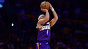 Dec 1, 2025; Los Angeles, California, USA; Phoenix Suns guard Devin Booker (1) shoots against the Los Angeles Lakers during the first half at Crypto.com Arena. Mandatory Credit: Gary A. Vasquez-Imagn Images