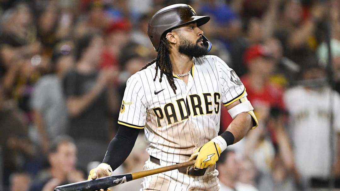 Sep 8, 2025; San Diego, California, USA; San Diego Padres right fielder Fernando Tatis Jr. (23) hits a walk-off sacrifice fly during the tenth inning against the Cincinnati Reds at Petco Park. 