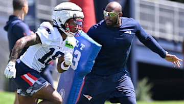 New England Patriots wide receiver Kyle Williams (18) works with a member of the coaching staff during training camp at Gillette Stadium.