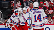 Nov 7, 2025; Detroit, Michigan, USA; New York Rangers left wing Artemi Panarin (10) celebrates his goal with center Mika Zibanejad (93) and right wing Taylor Raddysh (14) during the third period against the Detroit Red Wings at Little Caesars Arena. Mandatory Credit: Tim Fuller-Imagn Images