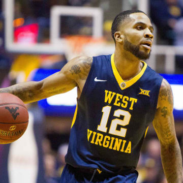 Mar 3, 2017; Morgantown, WV, USA; West Virginia Mountaineers guard Tarik Phillip (12) dribbles the ball during the first half against the Iowa State Cyclones at WVU Coliseum. 