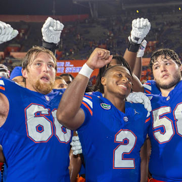 Florida Gators quarterback DJ Lagway (2) sings with Florida Gators offensive lineman Fletcher Westphal (68) and Florida Gators offensive lineman Austin Barber (58) at Ben Hill Griffin Stadium in Gainesville, FL on Saturday, September 7, 2024 after defeating the Samford Bulldogs 45-7. [Doug Engle/Gainesville Sun]