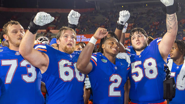 Florida Gators quarterback DJ Lagway (2) sings with Florida Gators offensive lineman Fletcher Westphal (68) and Florida Gators offensive lineman Austin Barber (58) at Ben Hill Griffin Stadium in Gainesville, FL on Saturday, September 7, 2024 after defeating the Samford Bulldogs 45-7. [Doug Engle/Gainesville Sun]