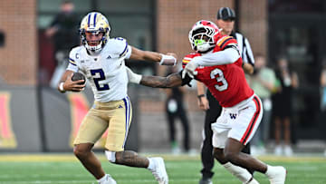Oct 4, 2025; College Park, Maryland, USA;  Washington Huskies quarterback Demond Williams Jr. (2) eludes the grasp of Maryland Terrapins linebacker Trey Reddick (3) in the second half at SECU Stadium. Mandatory Credit: Jamie Sabau-Imagn Images
