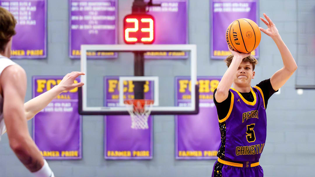 Peoria Christian's Tait Miller (23) puts up a three-pointer against Farmington with 23 seconds on the shot clock in the first half of their high school basketball game Friday, Feb. 13, 2026 in Farmington. The Farmers defeated the Chargers 75-65.