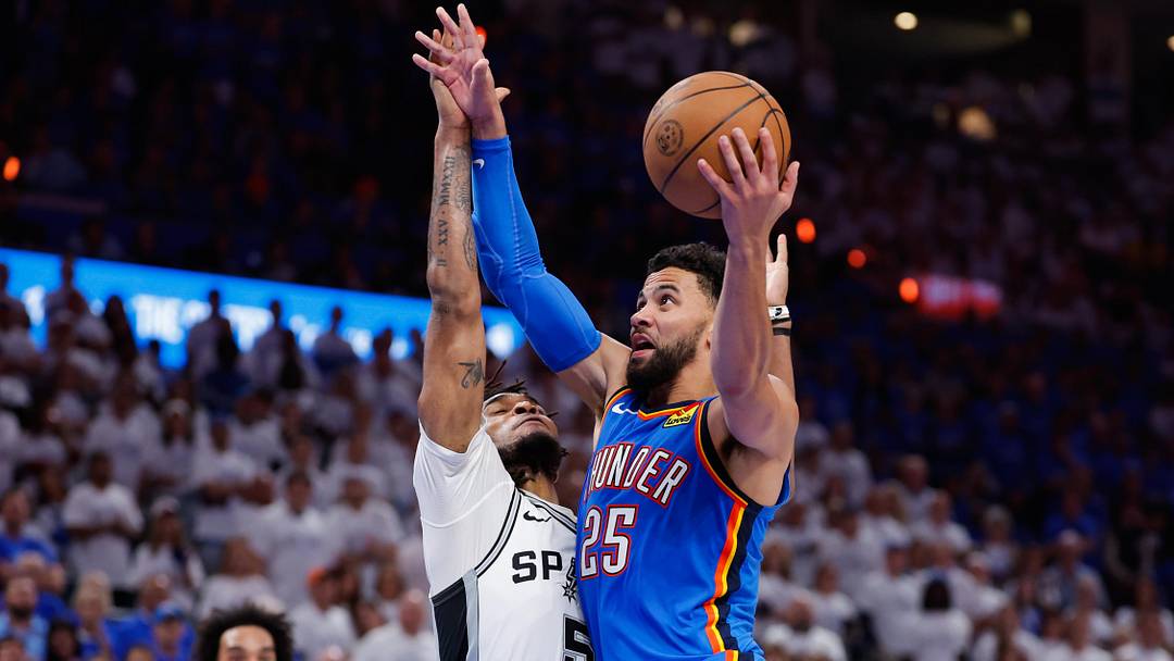 May 20, 2026; Oklahoma City, Oklahoma, USA; Oklahoma City Thunder guard Ajay Mitchell (25) drives to the basket as San Antonio Spurs guard Stephon Castle (5) defends during the fourth quarter during game two of the western conference finals for the 2026 NBA playoffs at Paycom Center. Mandatory Credit: Alonzo Adams-Imagn Images
