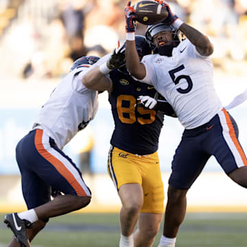 Nov 1, 2025; Berkeley, California, USA; Virginia Cavaliers linebacker Kam Robinson (5) intercepts a pass intended or California Golden Bears tight end Mason Mini (85) during the fourth quarter at California Memorial Stadium. Mandatory Credit: D. Ross Cameron-Imagn Images