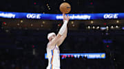 Oct 28, 2025; Oklahoma City, Oklahoma, USA; Oklahoma City Thunder guard Alex Caruso (9) shoots a three point basket against the Sacramento Kings during the second half at Paycom Center.