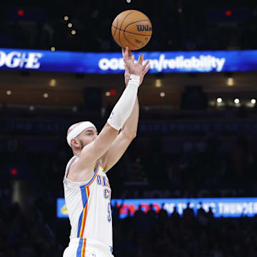 Oct 28, 2025; Oklahoma City, Oklahoma, USA; Oklahoma City Thunder guard Alex Caruso (9) shoots a three point basket against the Sacramento Kings during the second half at Paycom Center.