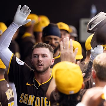 Mar 11, 2025; Peoria, Arizona, USA; San Diego Padres outfielder Jackson Merrill celebrates with teammates in the dugout after hitting a home run against the Chicago White Sox during a spring training game at Peoria Sports Complex. Mandatory Credit: Mark J. Rebilas-Imagn Images